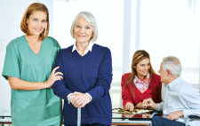 caregiver with senior people in nursing home